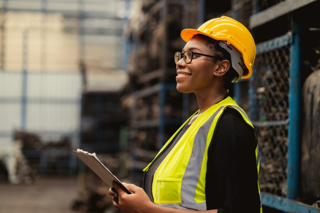 Happy Black African women engineer worker enjoy working in factory industry.